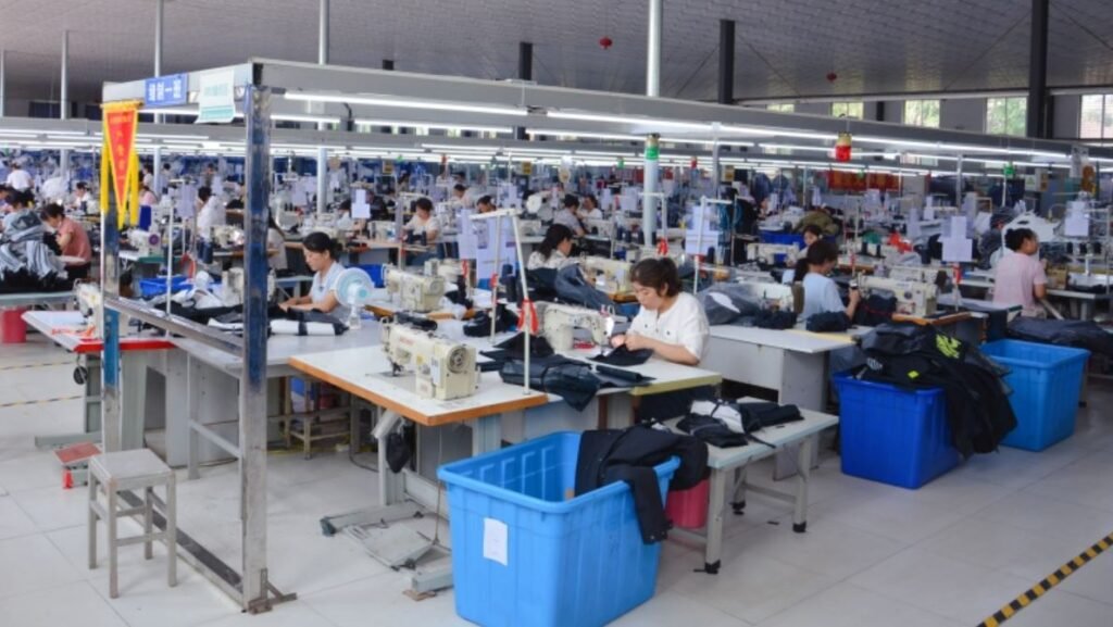 Garment workers sewing apparel in a large custom clothing manufacturer in China factory producing garments for global brands