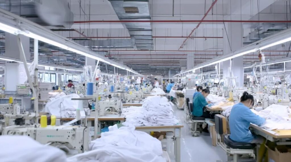 Large apparel production factory with workers sewing garments for global fashion brands through sourcing partners